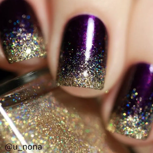 Deep royal glitter manicure with light gold french tips.